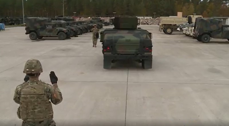 Soldiers ground guiding HMMWV